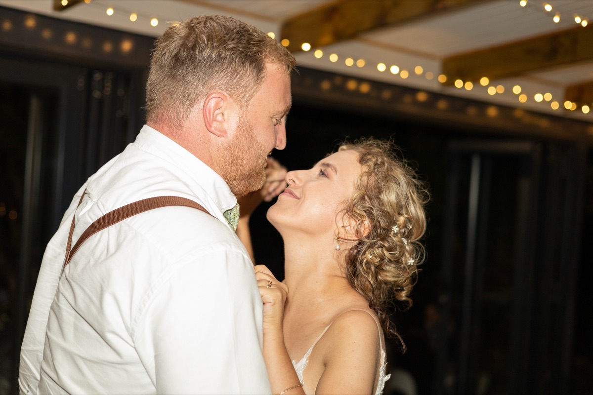 The first dance under strings of fairy lights after dark